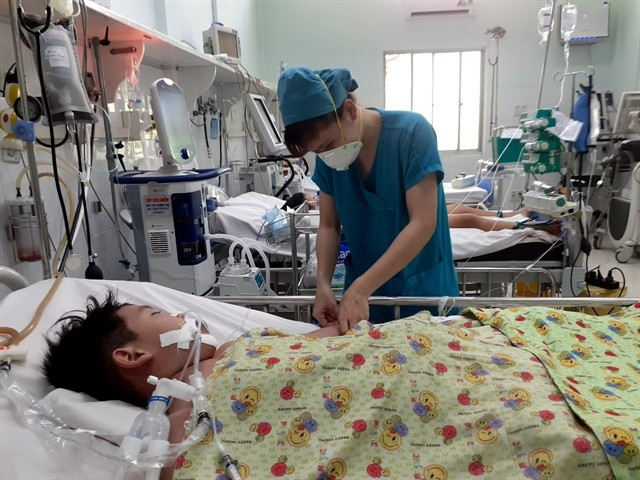 A child receives treatment for dengue fever at a hospital in HCM City. Six people have recently died as the city faces a sharp rise in cases. (Photo: VNA)